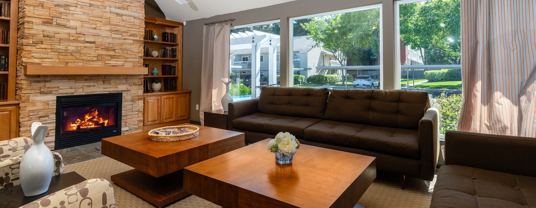clubroom with couches and fireplace